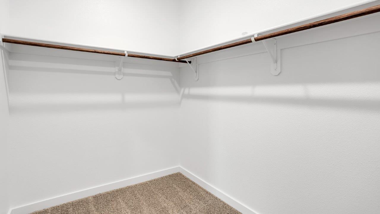 Private primary walk-in closet with extra storage space