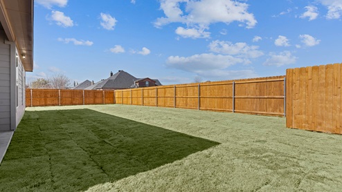 Landscaped spacious fenced in backyard