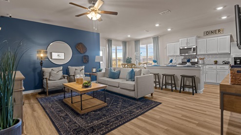 Interior spacious living room with lvp flooring and blue accent wall