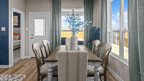 Dining room space to the side of the kitchen with blue accents