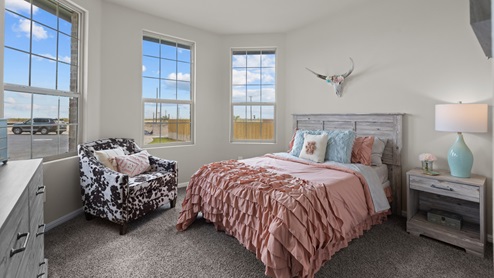 Front guest bedroom with light allowing bow windows decorated as a little girl's room