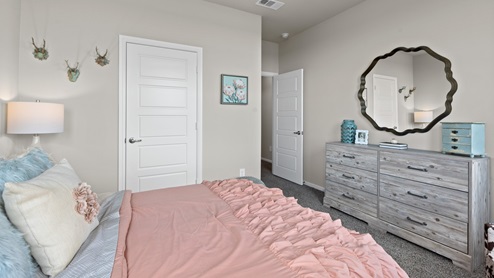 Front guest bedroom designed as a young girl's bedroom with walk-in closet