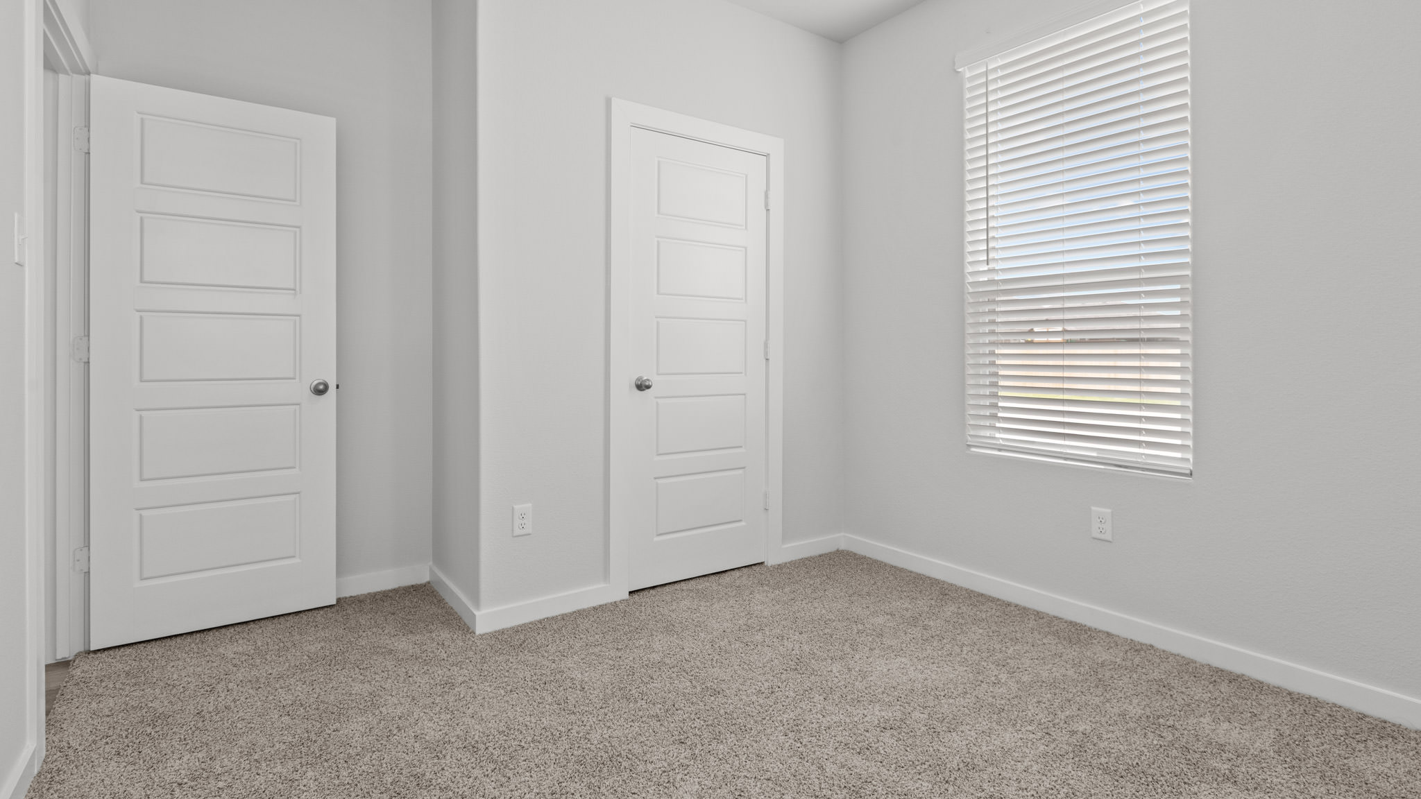 Guest bedroom 2 with side window and plush carpet floor