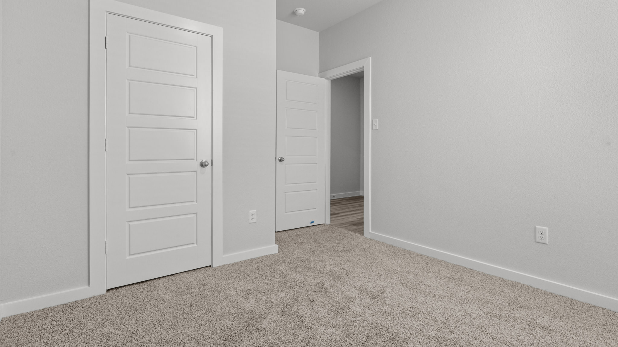 Guest bedroom 1 with front windows and ample natural light