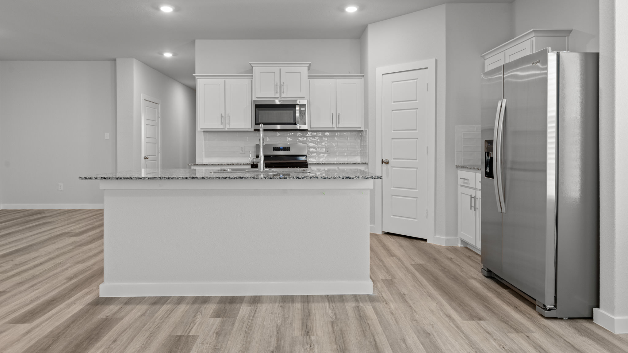 Spacious open concept kitchen with island and counter prep space