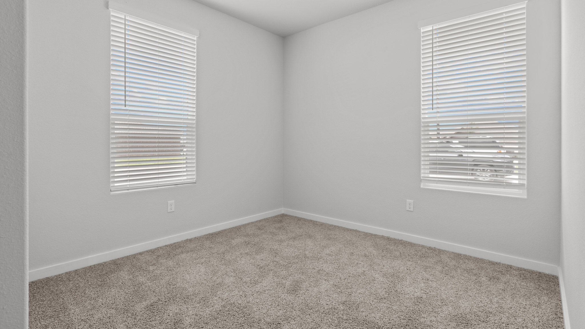 Guest bedroom 1 with front windows and ample natural light