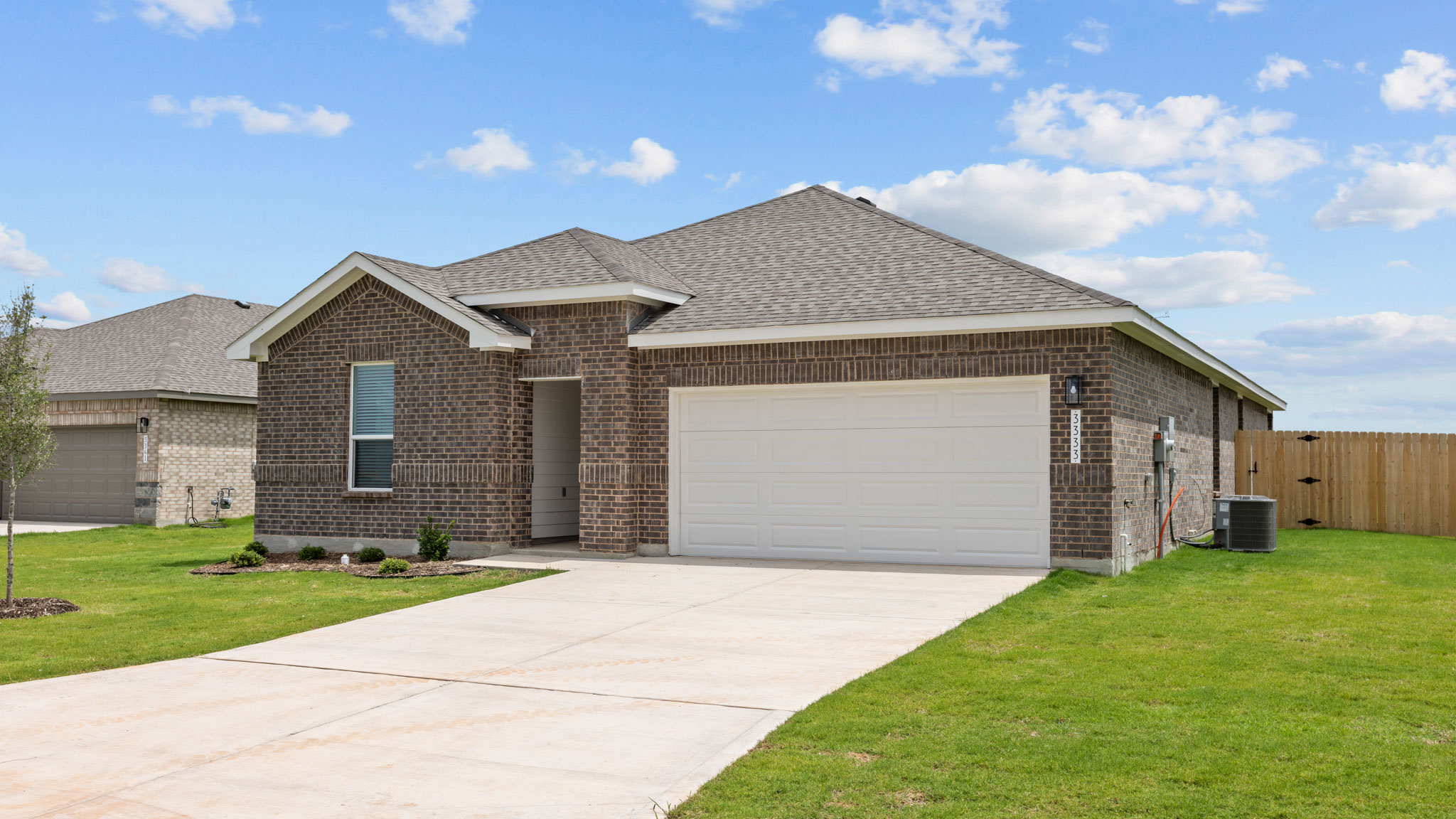 Side view of single story timeless brick home