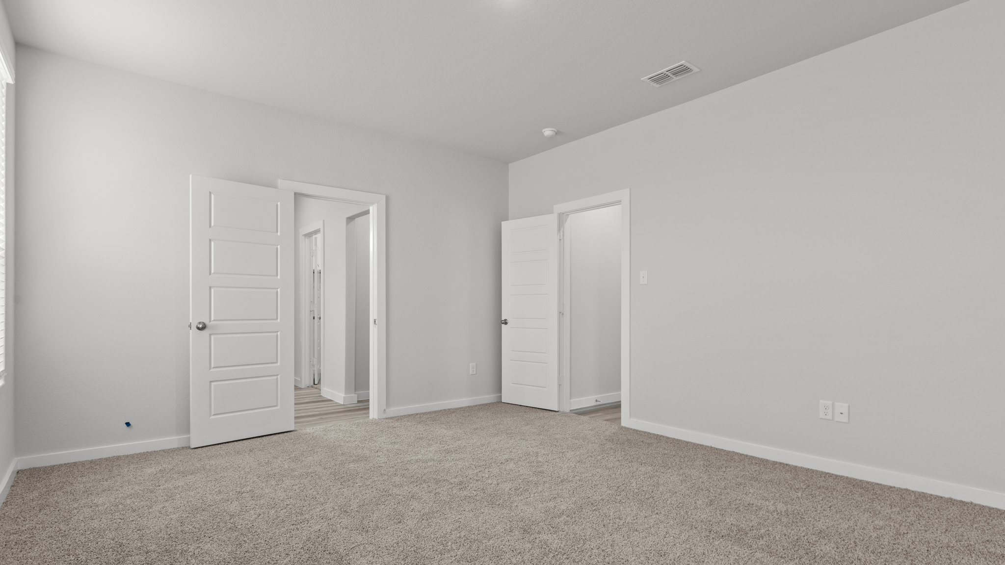 Primary bedroom with private attached bathroom and walk-in closet