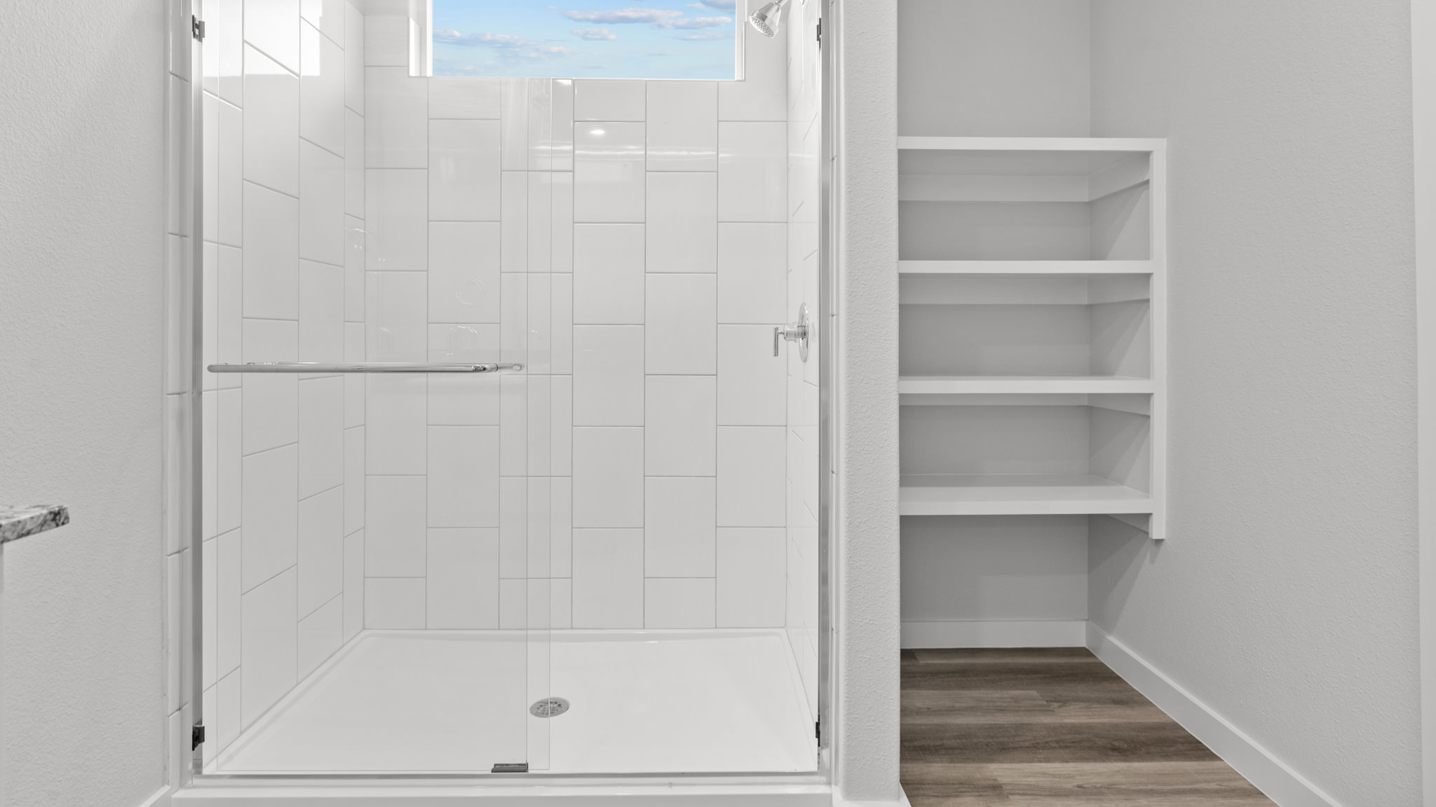 Primary bathroom with luxurious shower and built in storage