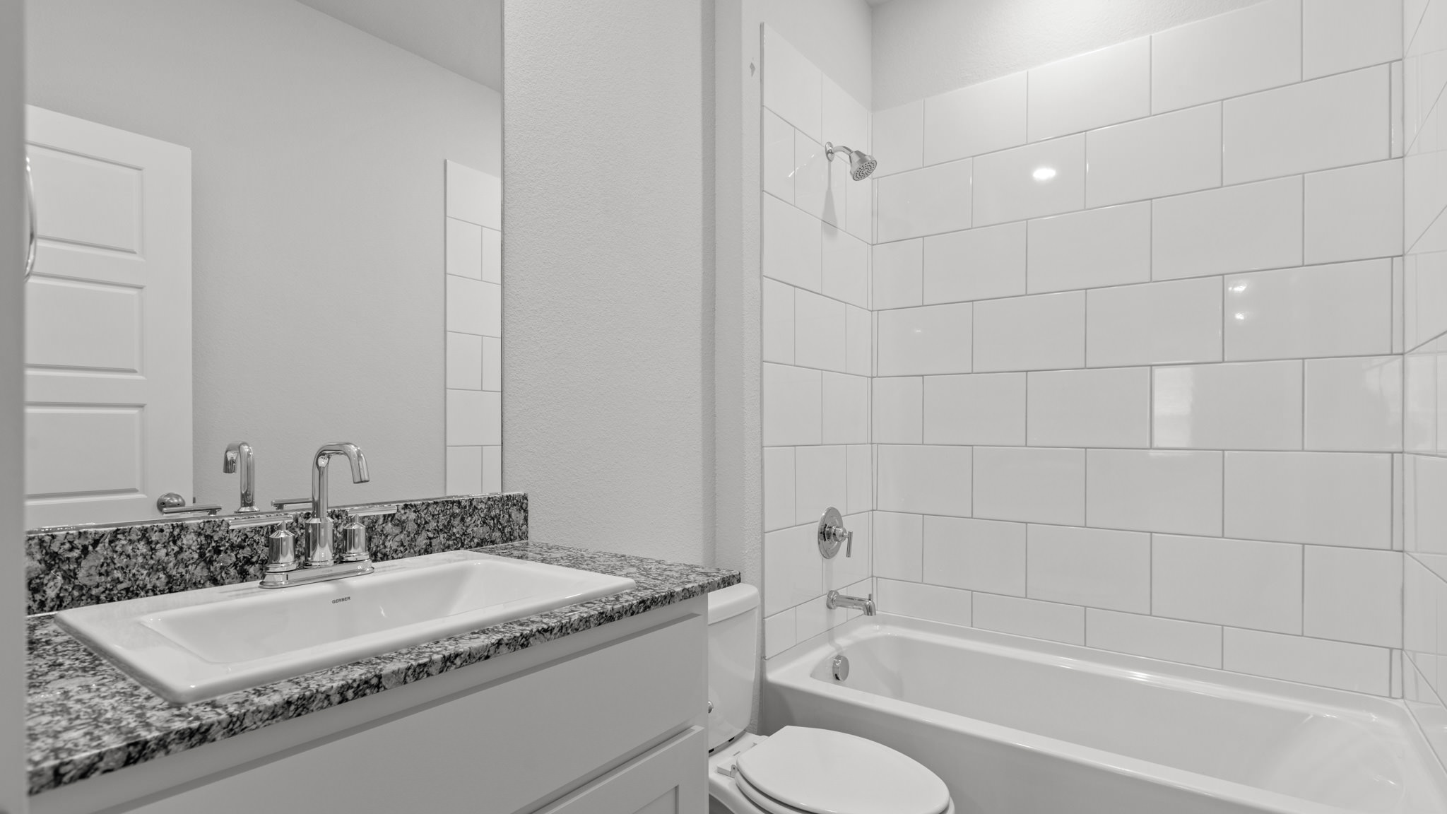 Guest bathroom with built in vanity and combination bathtub shower