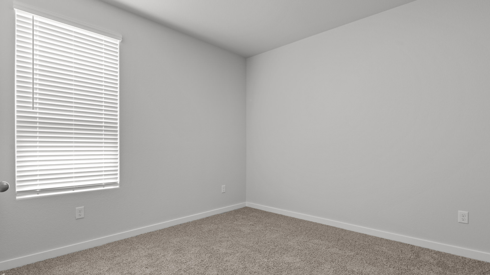 Guest bedroom 4 with plush carpet and side window