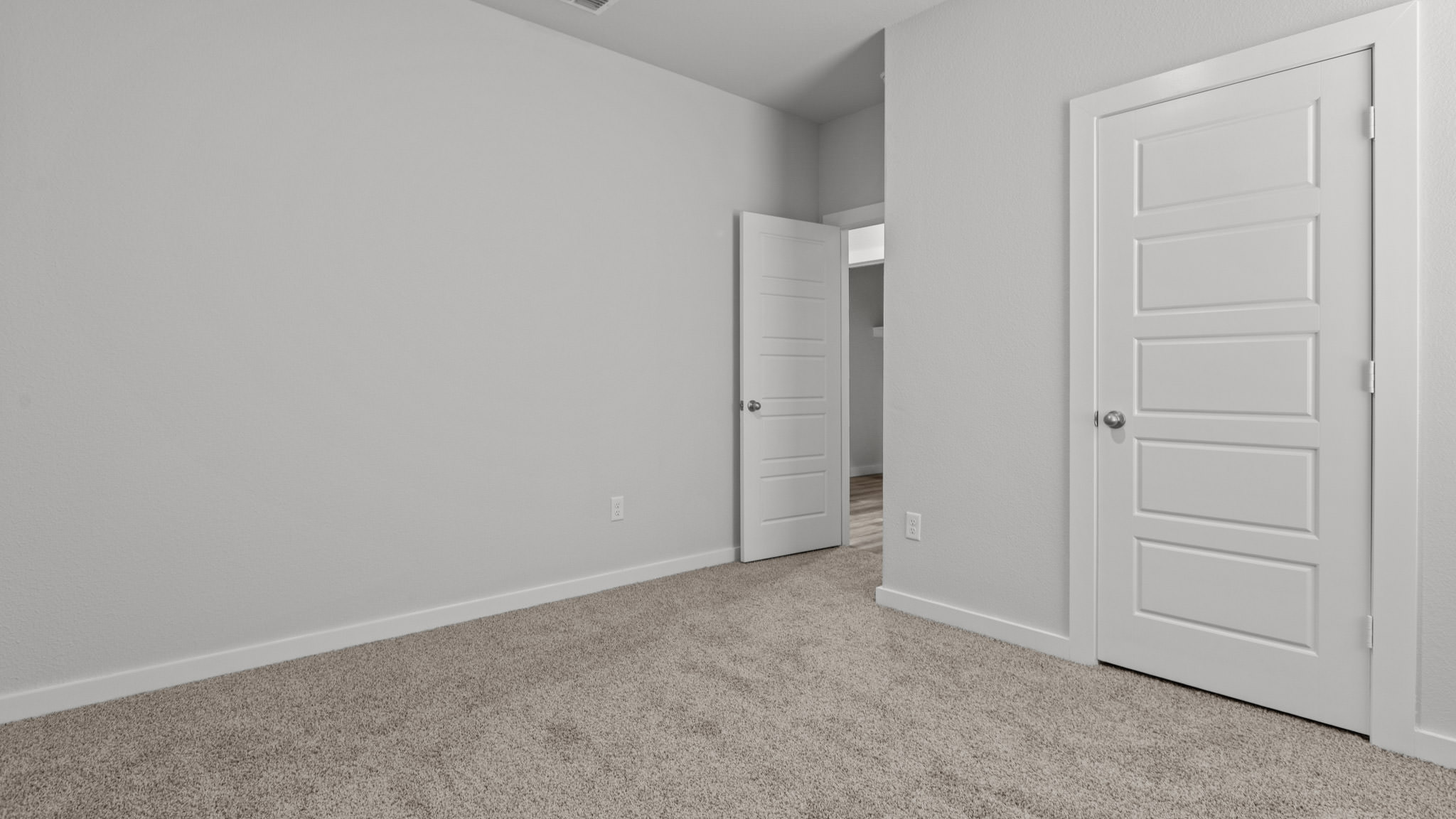 Guest bedroom 4 with plush carpet and side window