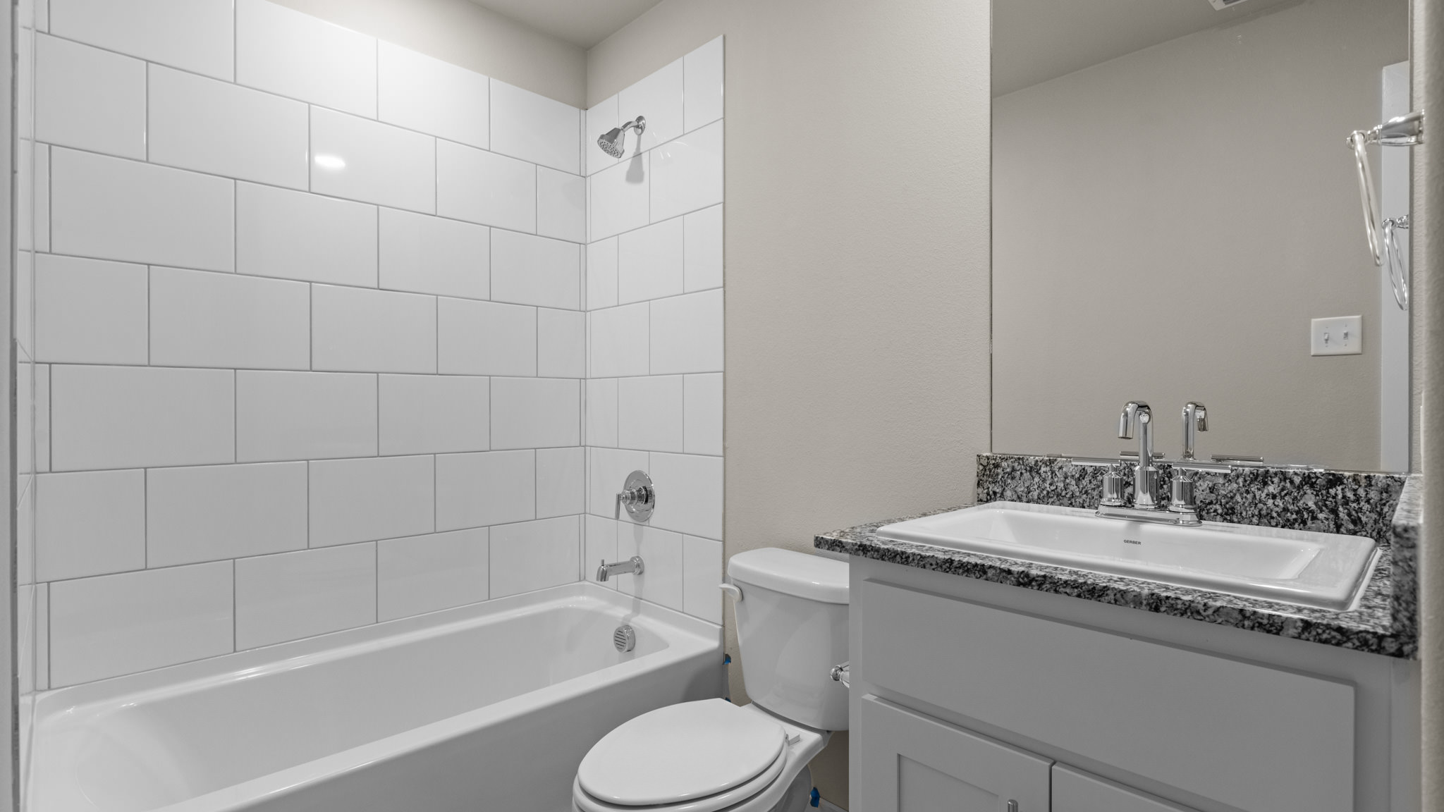 Guest bathroom with built in vanity and combination bathtub shower