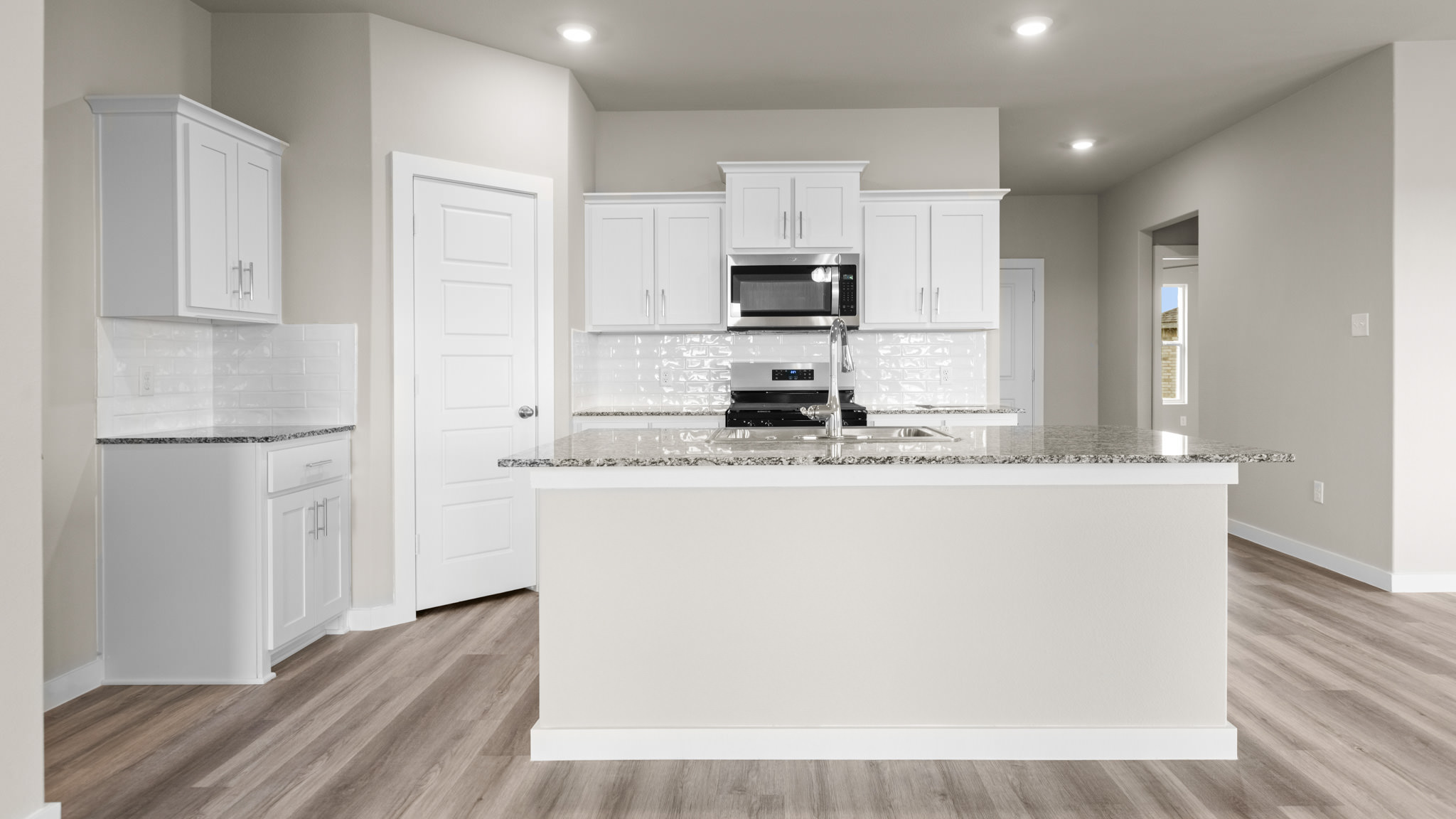 Spacious open concept kitchen with island and counter prep space