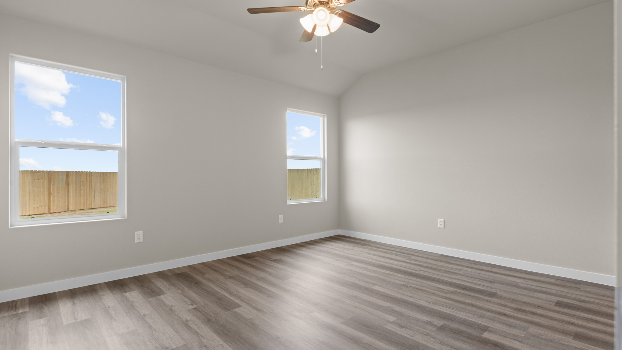 Primary bedroom with standard plush carpet floors and light allowing double windows