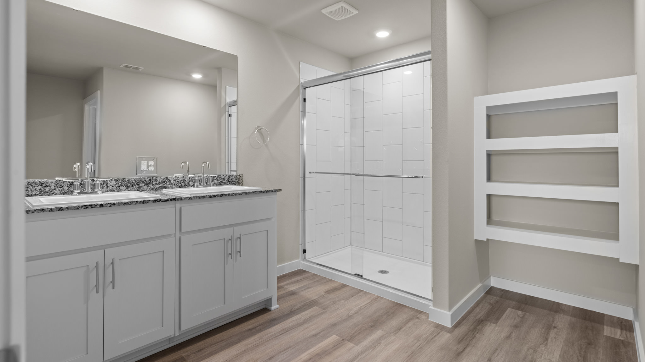 Primary bathroom with built in vanity and luxurious shower