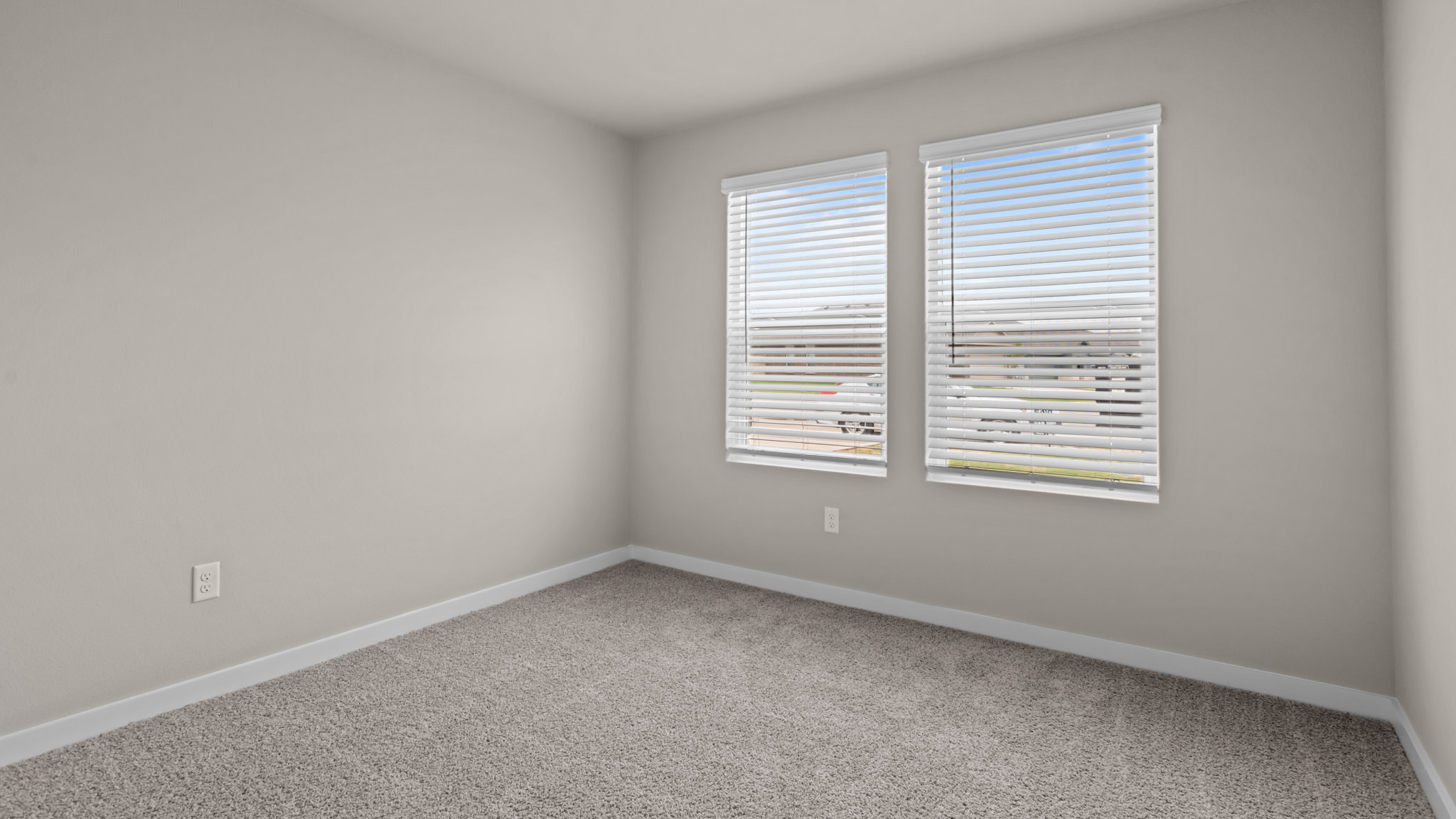 Guest bedroom 1 with front windows and ample natural light