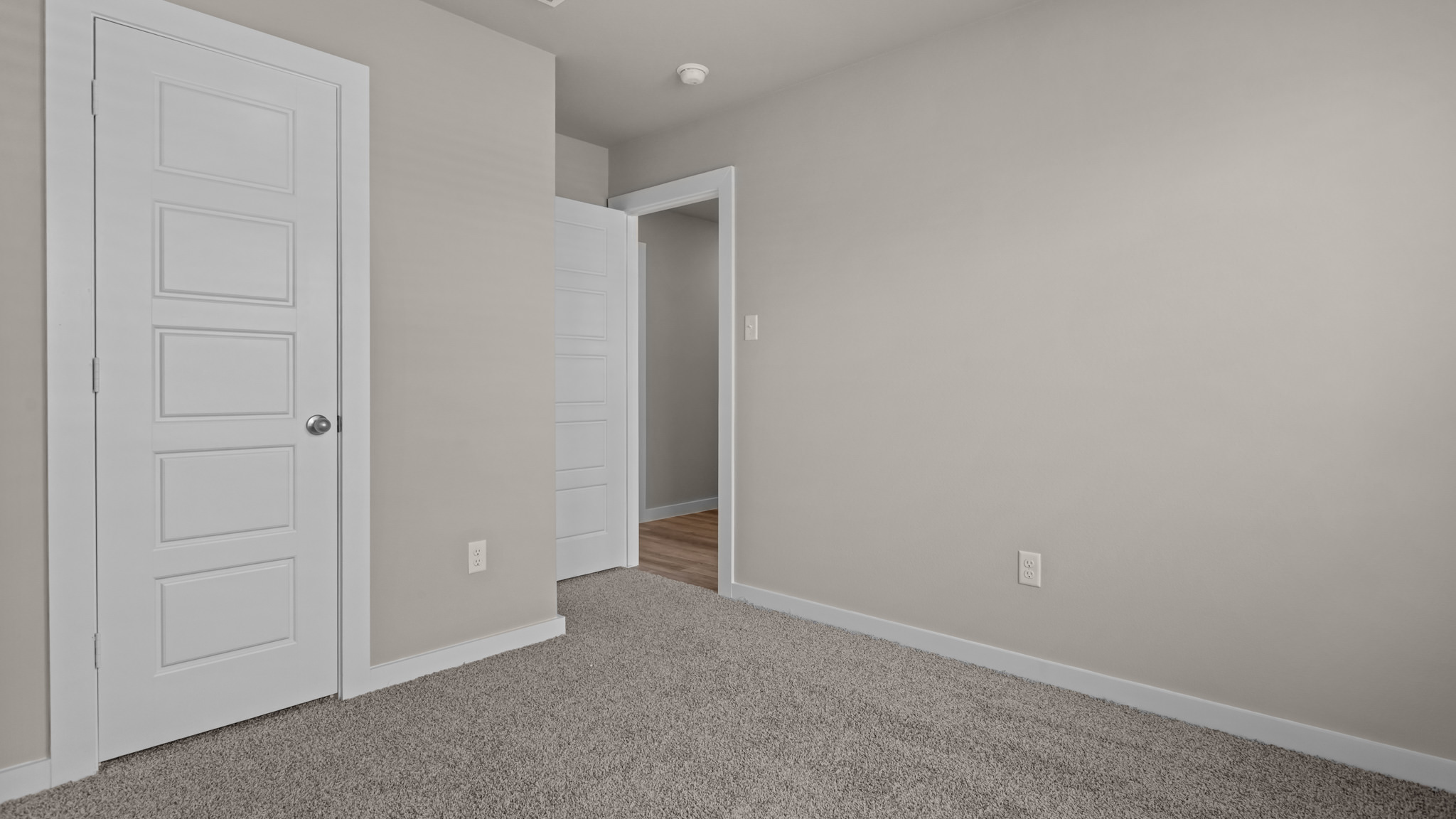 Guest bedroom 2 with side window and plush carpet floor