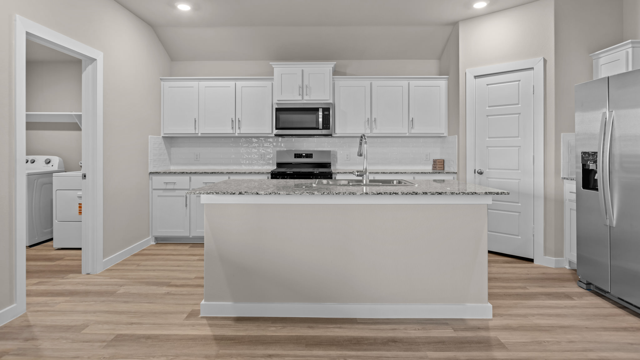 Spacious open concept kitchen with island and counter prep space