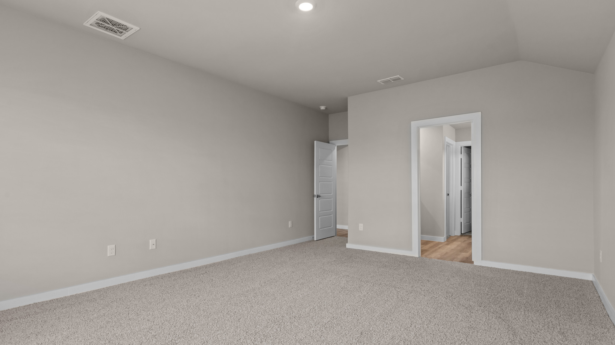 Primary bedroom with private attached bathroom and walk-in closet