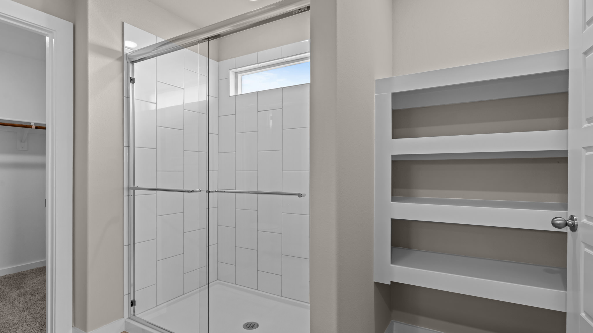 Primary bathroom with luxurious shower and built in storage