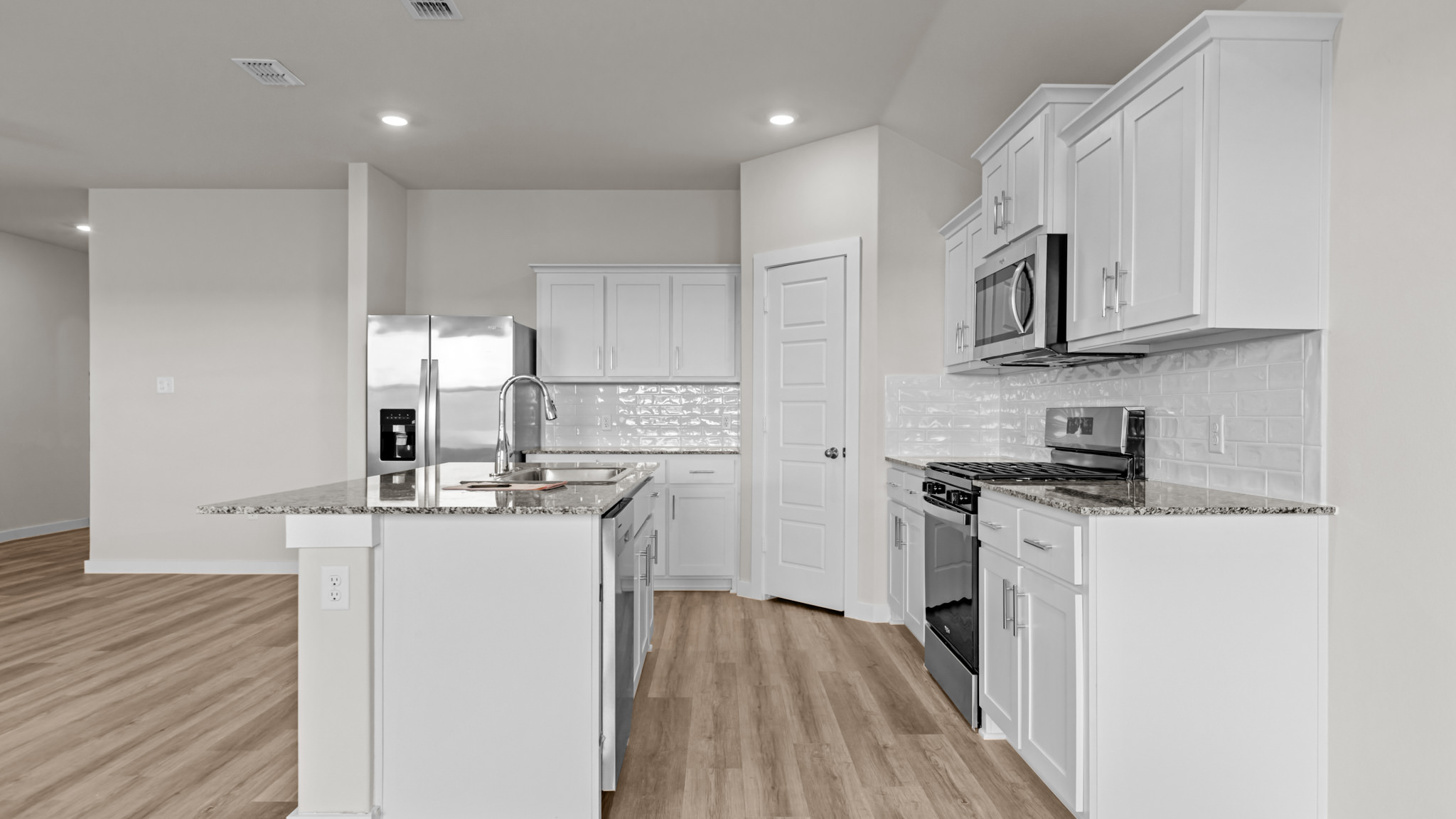 Spacious open concept kitchen with island and counter prep space