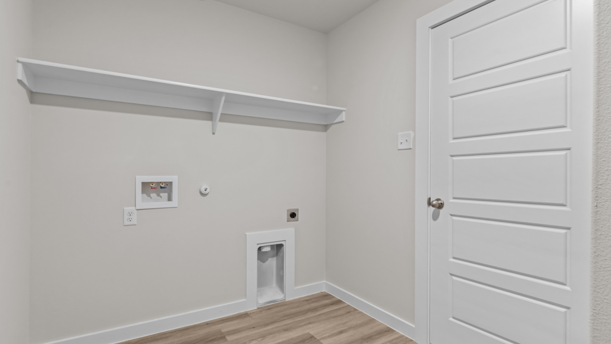 Laundry room and utility closet space with extra storage