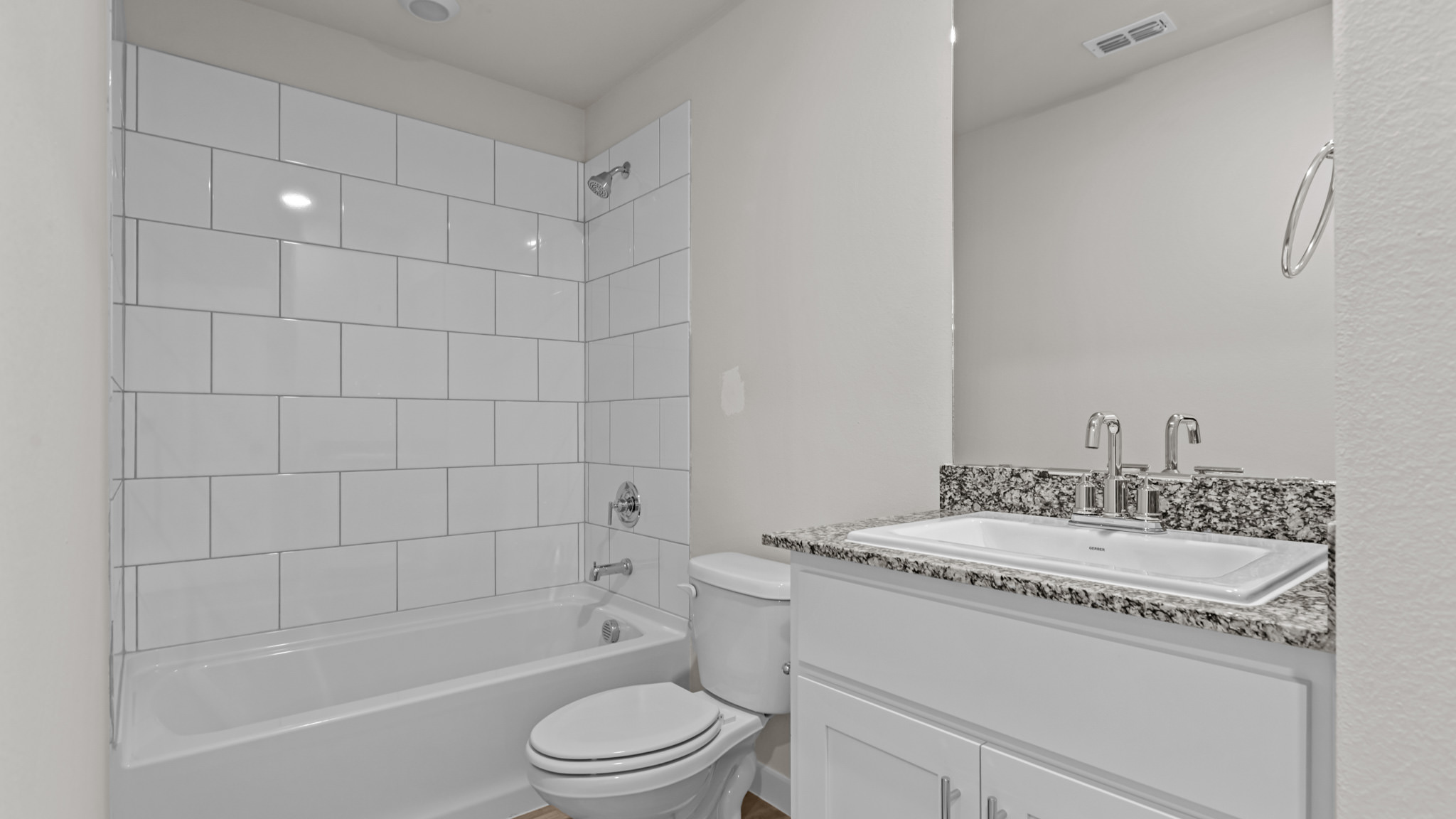 Guest bathroom with built in vanity and combination bathtub shower