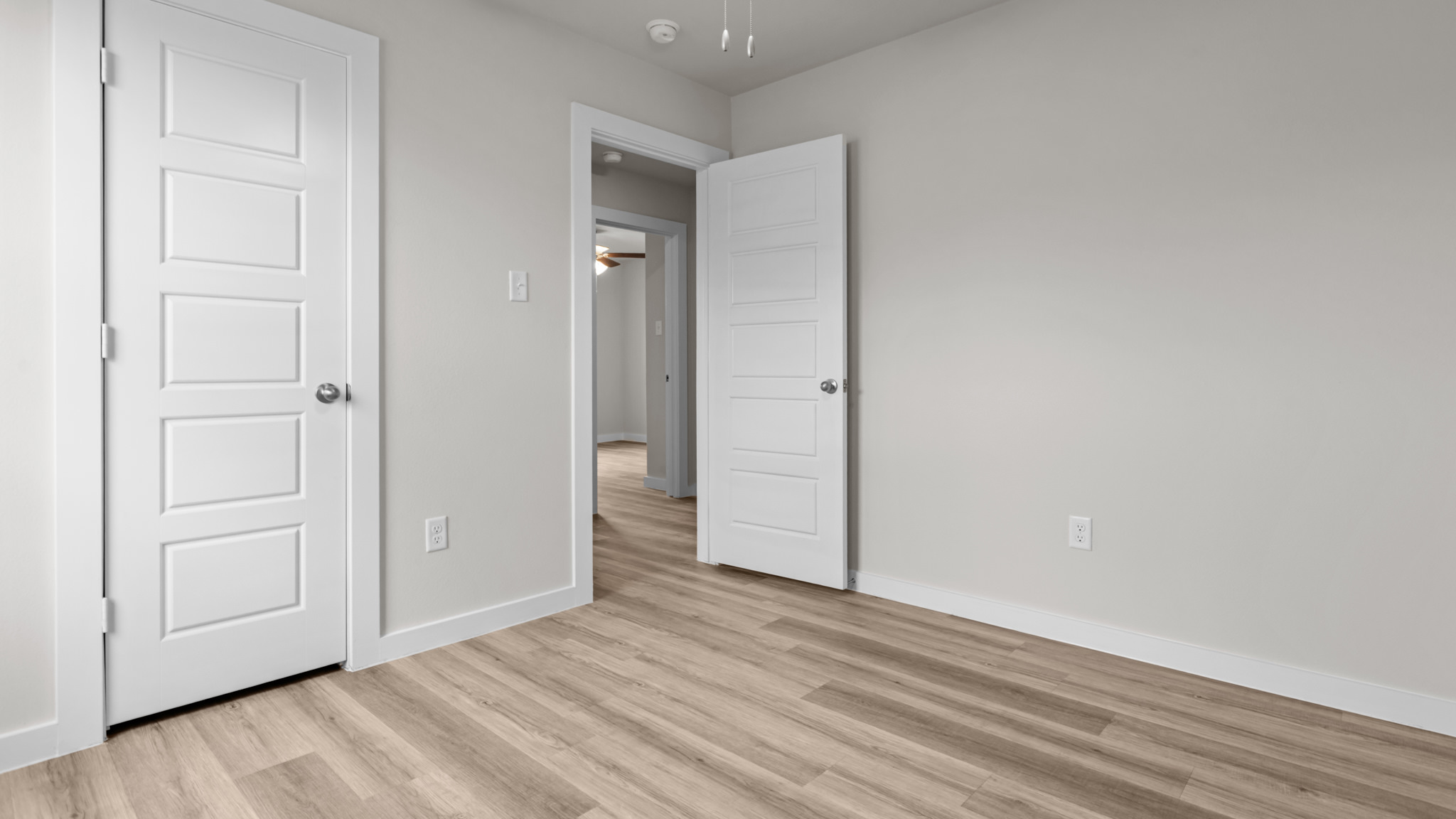 Guest bedroom 2 with side window and plush carpet floor