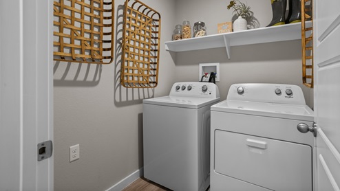 Laundry room and utility closet space with extra storage