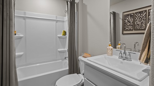Guest bathroom with built in vanity and combination bathtub shower