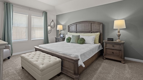 Primary bedroom with plush carpet floors and light allowing double windows