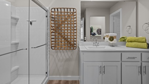 Private attached primary bathroom with built in vanity