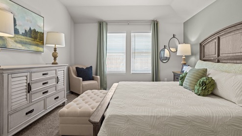 Primary bedroom with plush carpet floors and light allowing double windows
