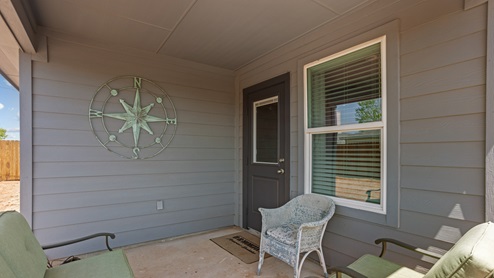 Covered back patio area overlooking spacious backyard