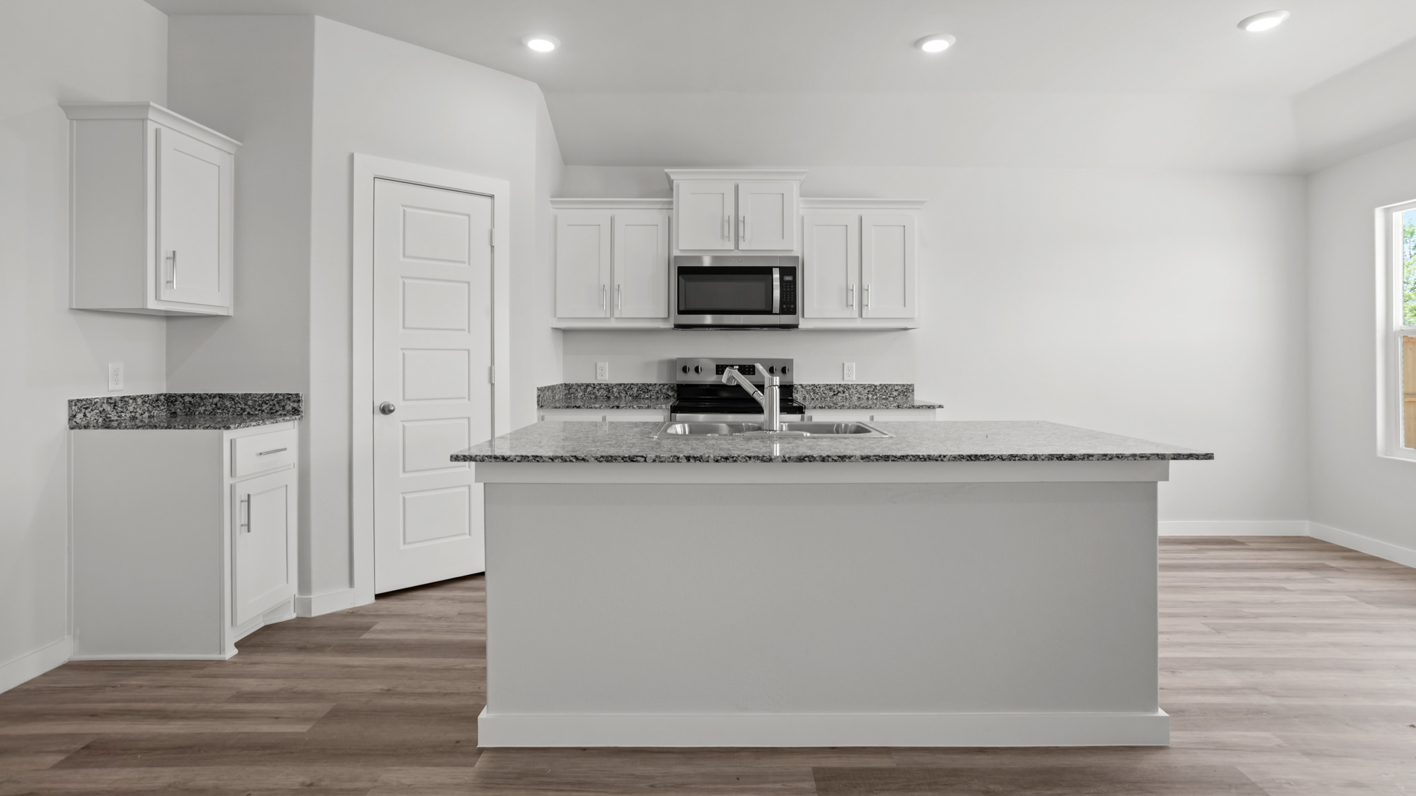 Spacious open concept kitchen with island and counter prep space