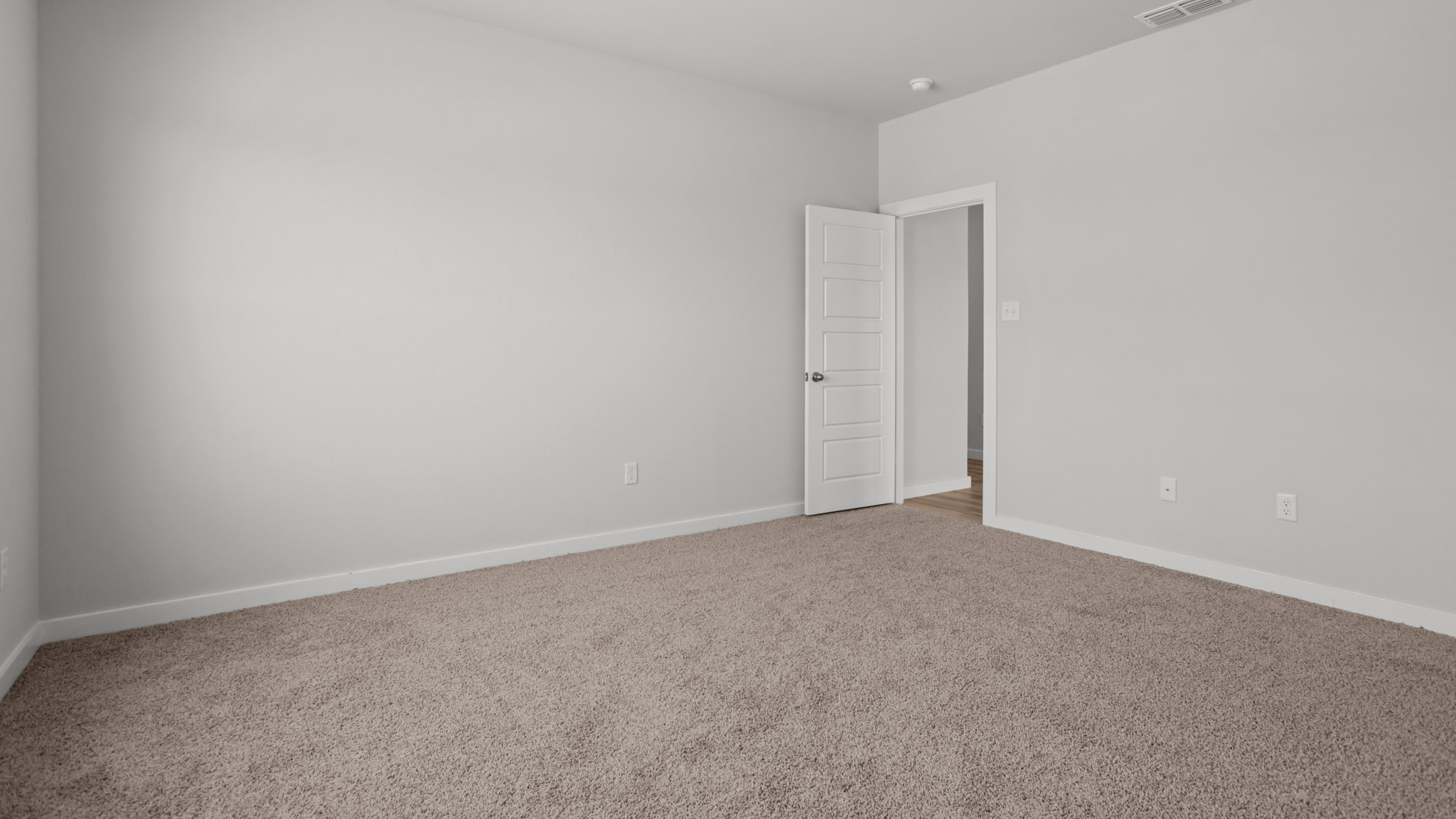 Primary bedroom with private attached bathroom and walk-in closet