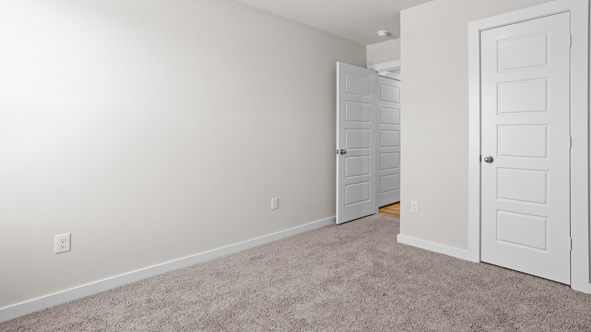 Guest bedroom 1 with front windows and ample natural light