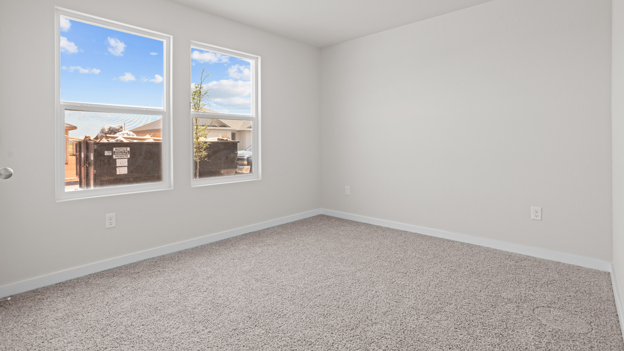 Guest bedroom 1 with front windows and ample natural light