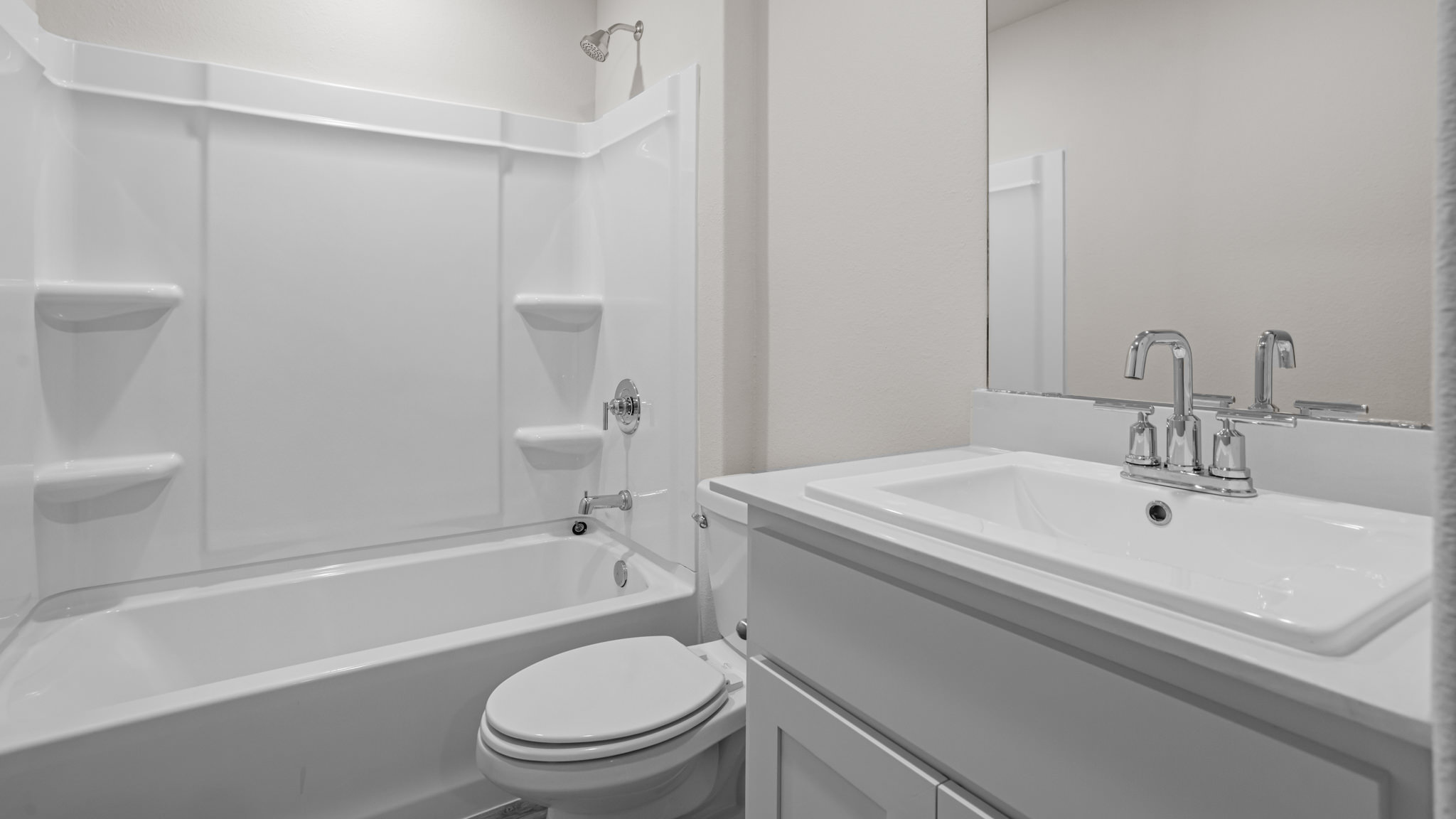 Guest bathroom with built in vanity and combination bathtub shower