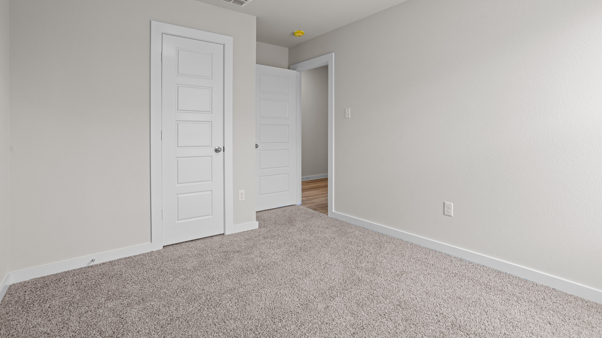 Guest bedroom 3 with plush carpet floors and spacious closet