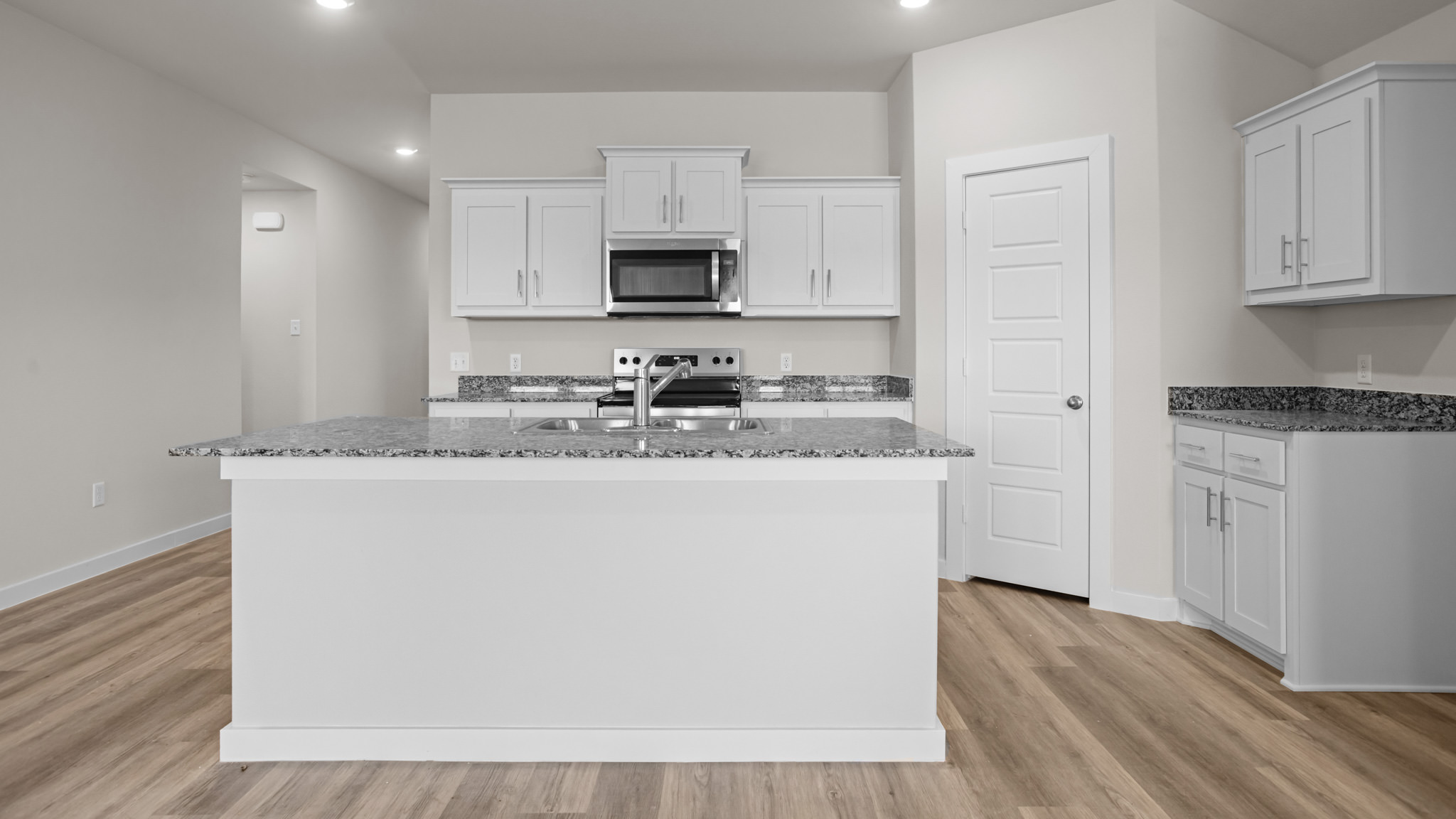 Spacious open concept kitchen with island and counter prep space