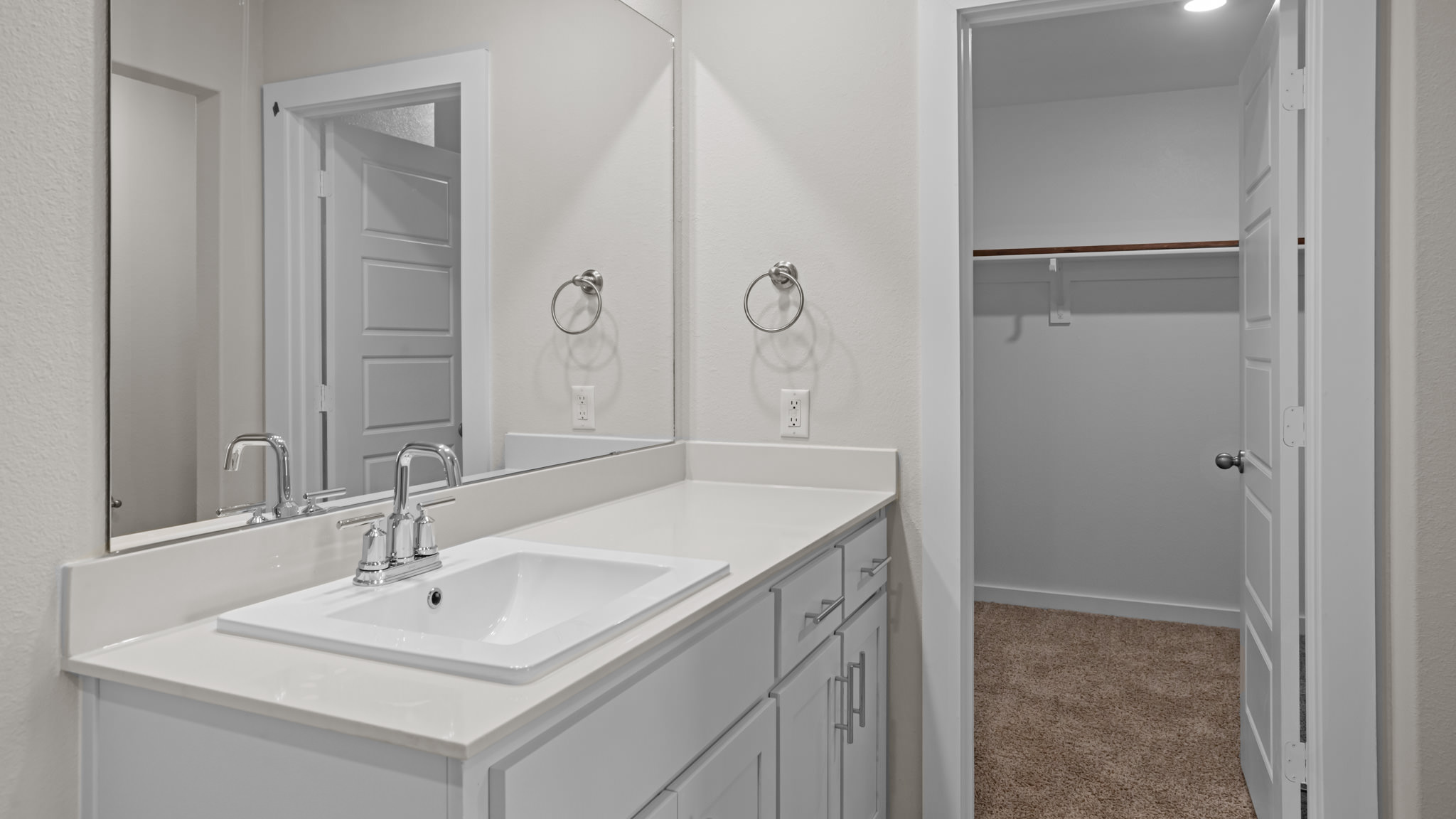 Private attached primary bathroom with built in vanity