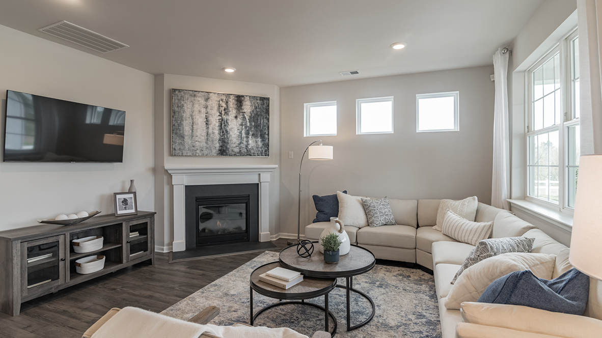 The cozy living area has a double window and fireplace.