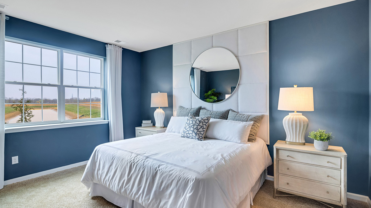 Primary bedroom with large double window.