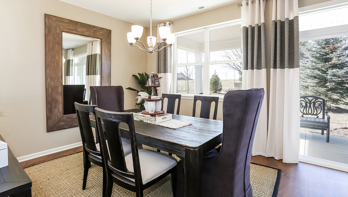 Views of the modern cozy dining area with glass sliding door to the back porch.