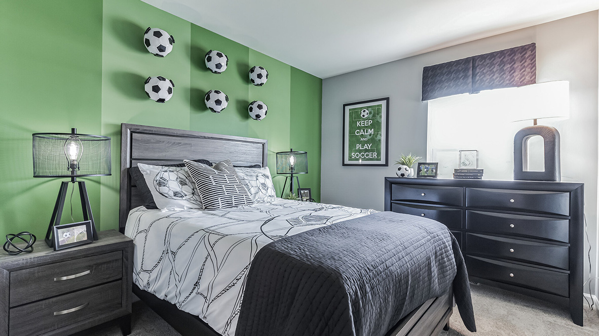 Second bedroom upstairs soccer themed with large single window.
