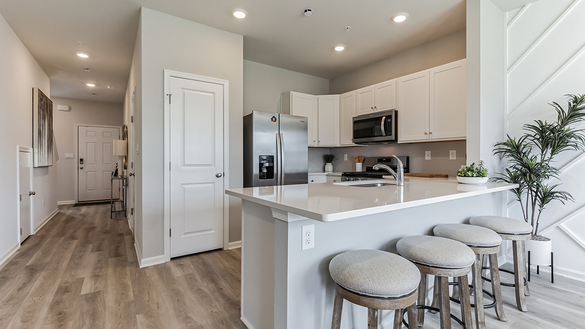Kitchen area to the left and view into the foyer.