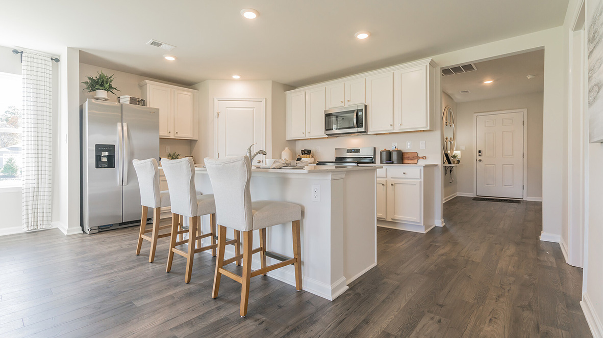 The home's well-designed kitchen features tasteful white cabinetry and stainless steel appliances.
