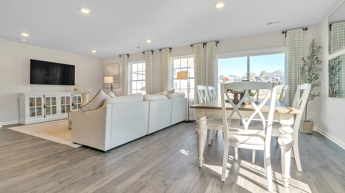 The ample great room and dining area both offer an abundance of natural light.